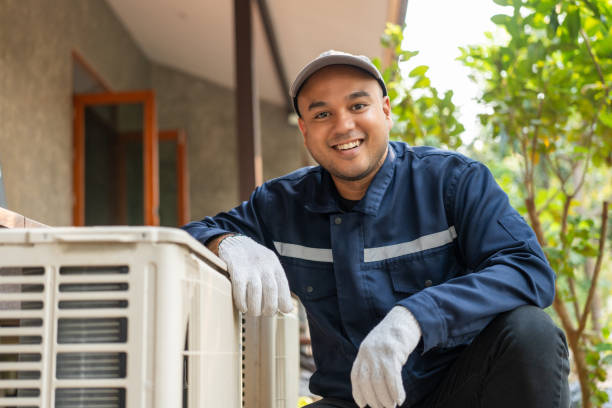 Air conditioning service outdoor inspection repair. Air conditioning cleaning technician Opened the front panel, took out the filters and washed them. In uniform, wearing rubber
